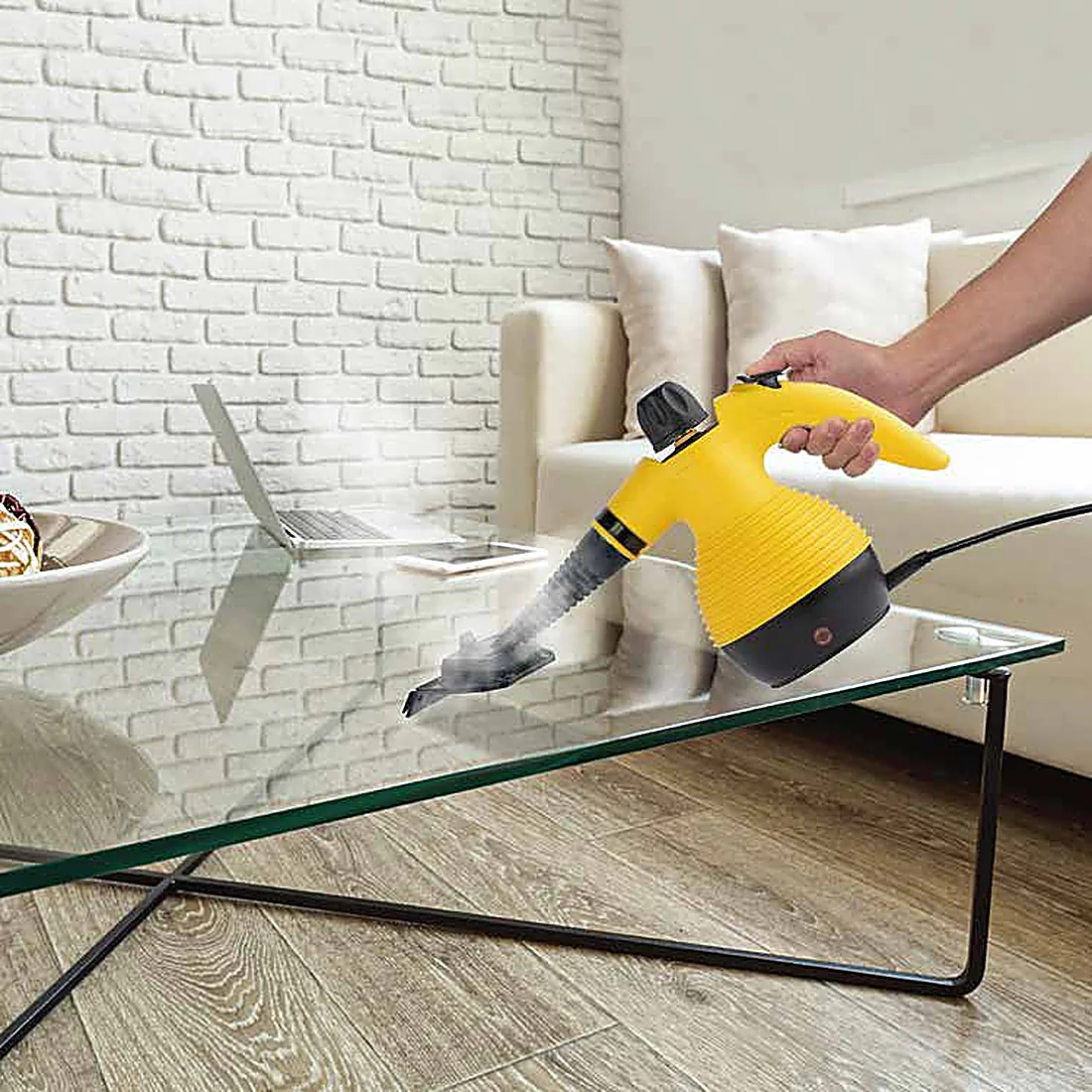 Handheld steam cleaner on upholstery